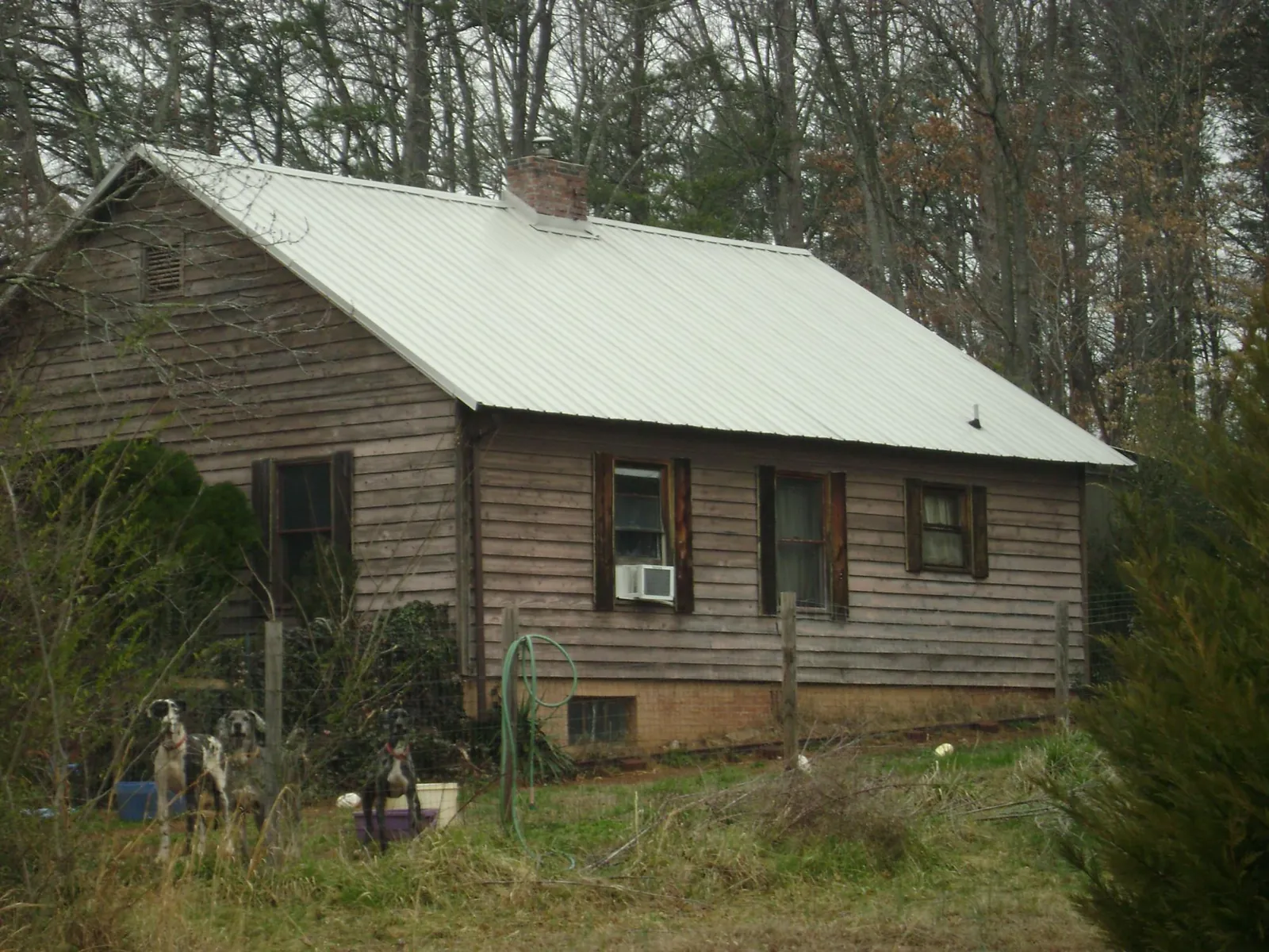White metal roof on an old wood sided farmhouse, from a Metal Roof Installation job in Altoona